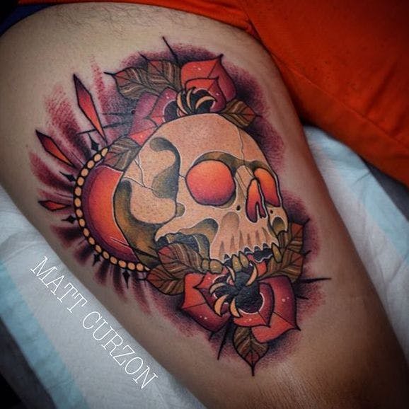 Colored traditional skull with flowers tattoo on inner arm