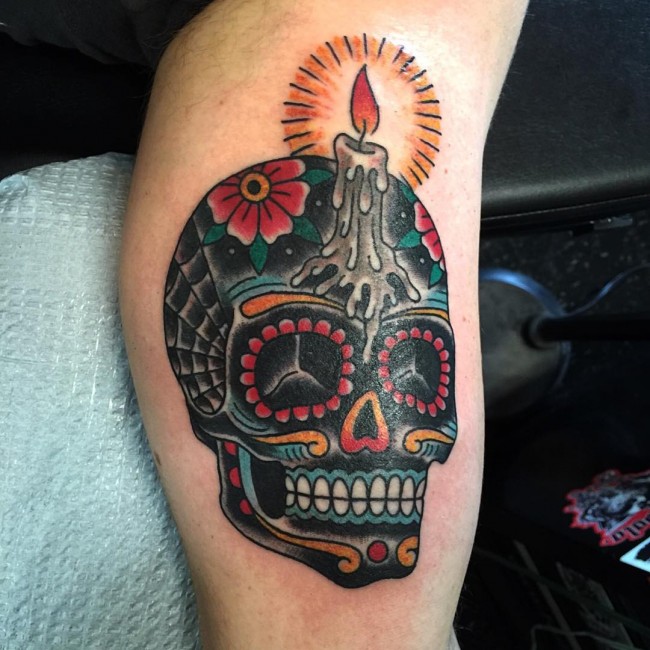 Colored traditional sugar skull with candle on body