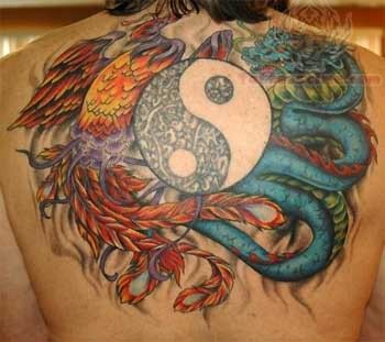 Colorful Dragon and snake tattoo with yin yang symbol on upper mid back