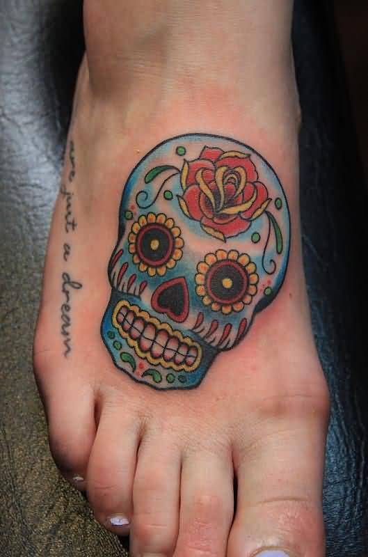 Colorful sugar skull and rose tattoo on right foot for women