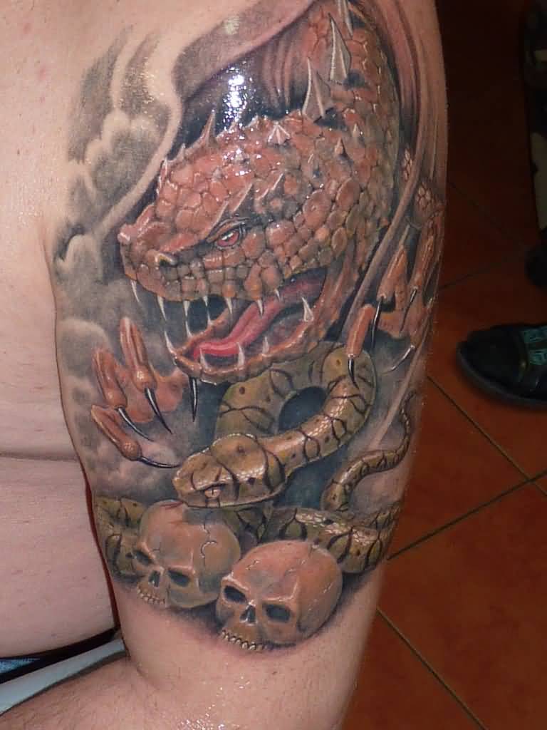 Colored dragon and rattle snake tattoo on left biceps