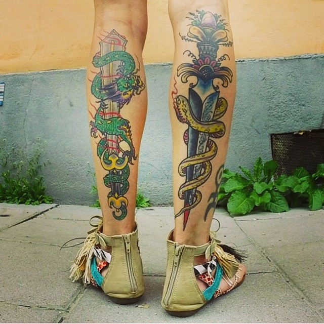 Colorful dragon and snake tattoo with knife and sword on calf