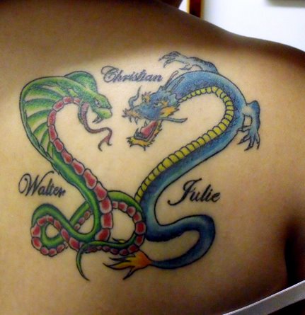 Green and blue dragon and snake tattoo with names on upper right back of woman