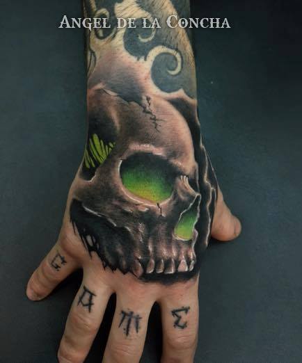 Green eyes skull tattoo on right hand