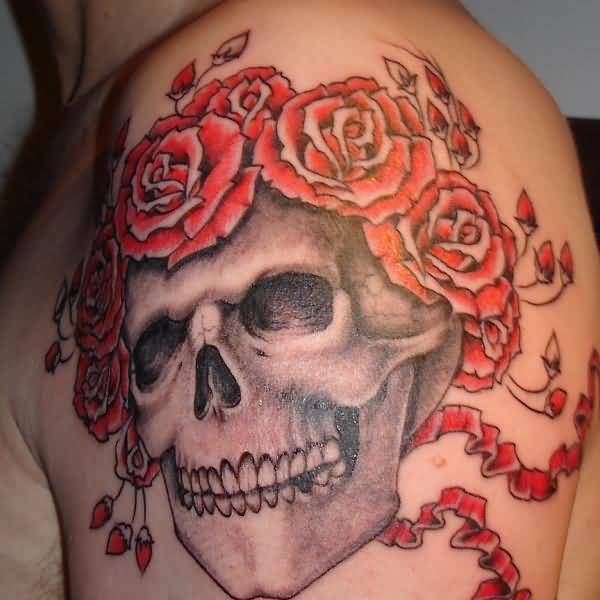 Grey and red shaded skull and roses tattoo on upper left arm