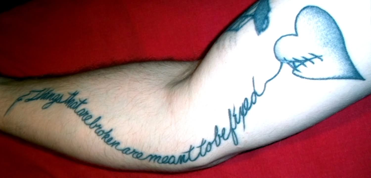 Grey sewed broken heart tattoo on arm