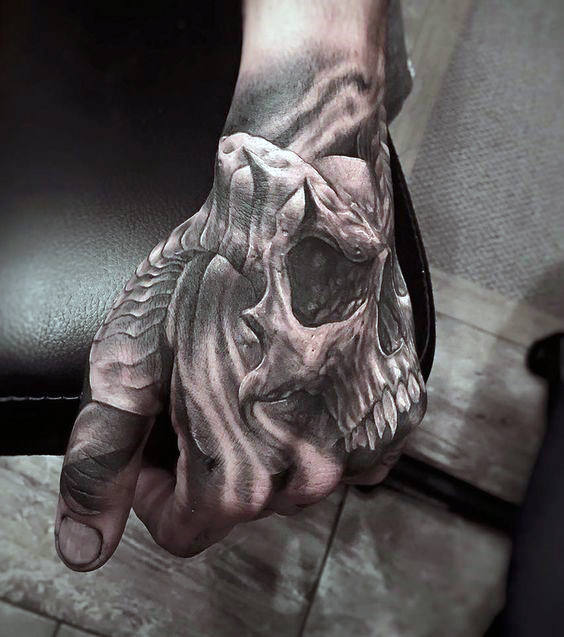 Grey shaded left view of skull tattoo on left hand