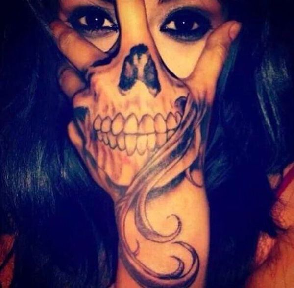 Grey shaded optical illusion skull tattoo on hand for women