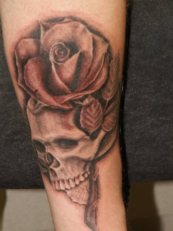 Grey shaded skull and rose tattoo on arm