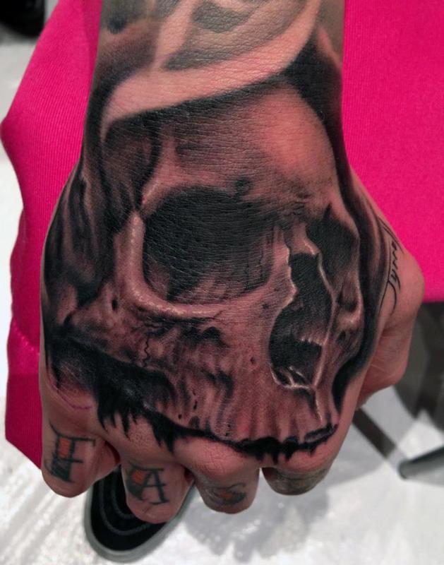 Grey shaded skull tattoo hand tattoo