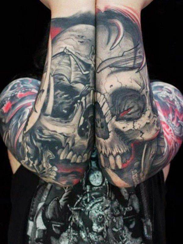 Grey shaded skull tattoo on both lower sleeves