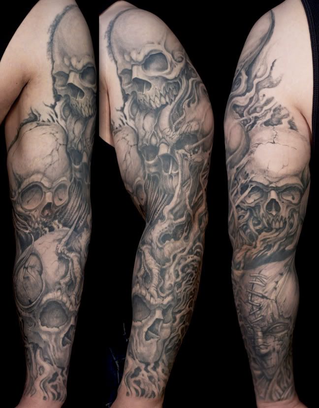 Grey shaded skull tattoo on left full sleeve for men