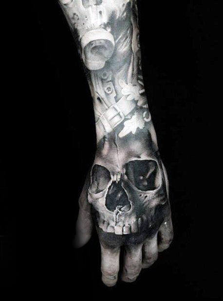 Grey shaded skull tattoo on left hand for men