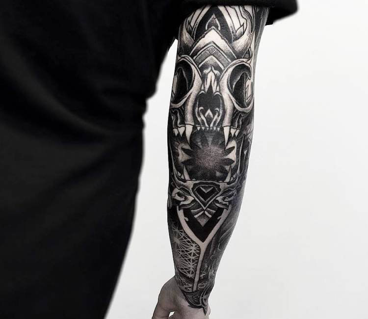 Grey shaded skull tattoo on sleeve for men