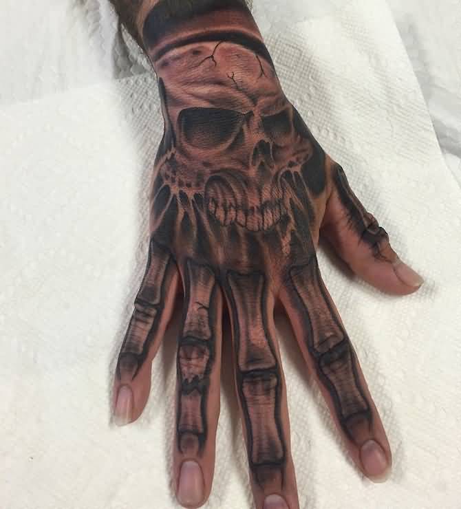 Grey shaded skull with bones tattoo on hand