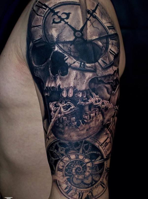 Grey shaded skull with clock tattoo on upper sleeve