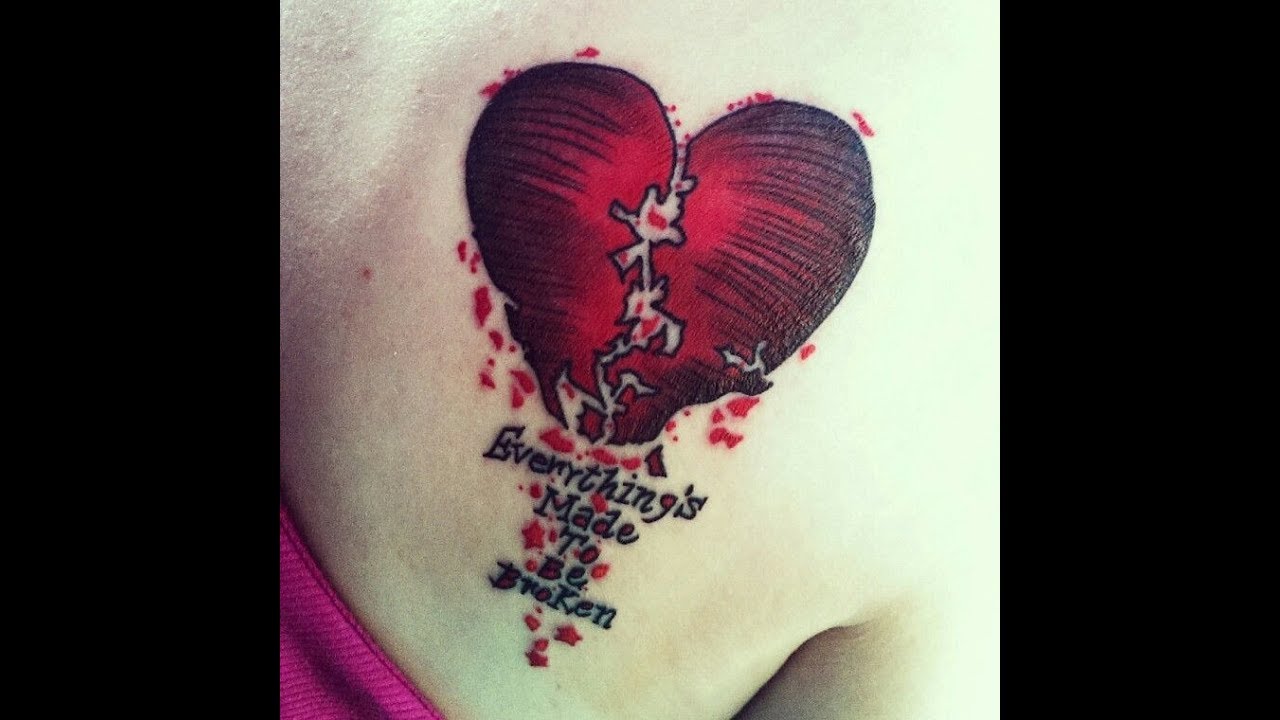 Red and black broken heart tattoo on right upper back for women