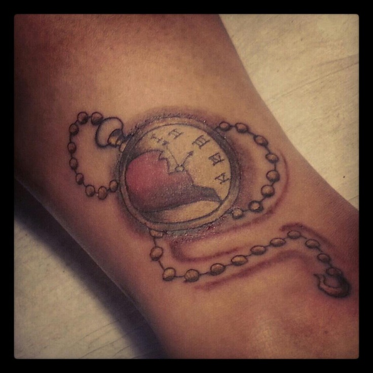 Red and black shaded watch with half broken heart tattoo on arm