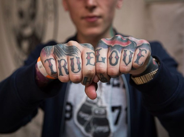 Red and black true love wording knuckle tattoo