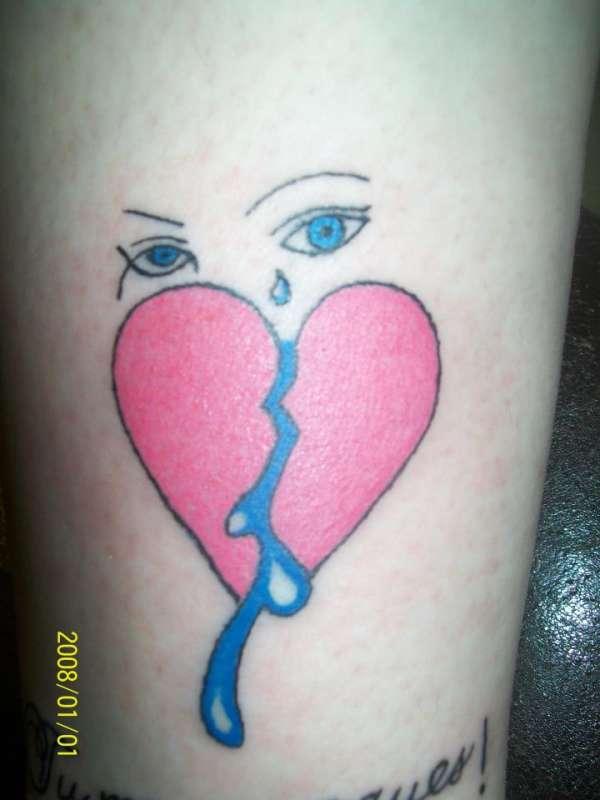 Red and blue tearful eyes broken heart tattoo on arm