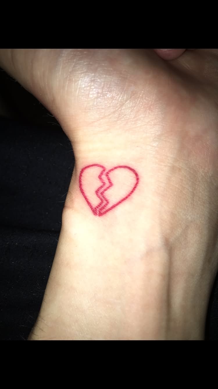 Red broken heart tattoo on left hand wrist