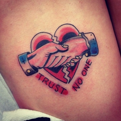 Red trust no one broken heart tattoo on body