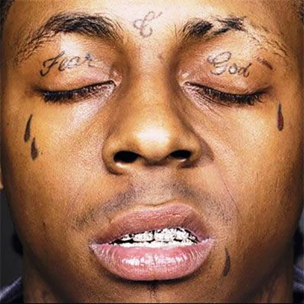 Black filled teardrop tattoo below left and right eye for men