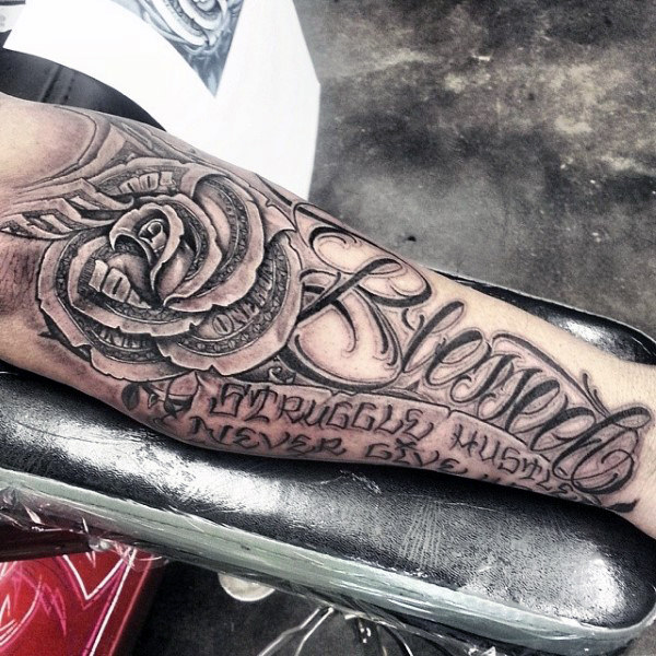 Black and grey shaded rose with blessed tattoo on inner forearm