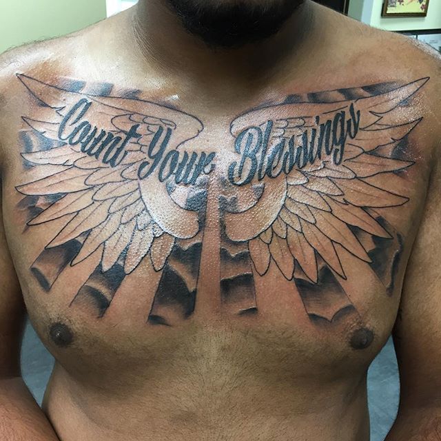 Black angel wings and sun rays count your blessings tattoo on chest for men
