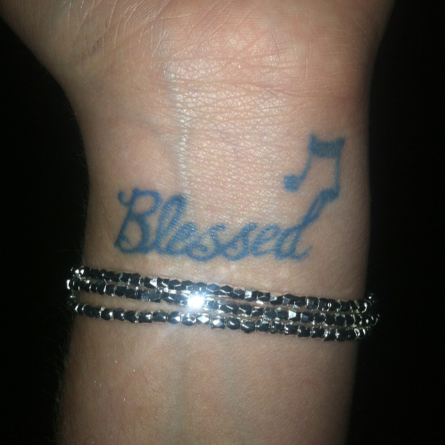 Black blessed with music note tattoo on inner wrist for women