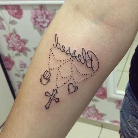 Black celtic cross and heart blessed tattoo on inner arm