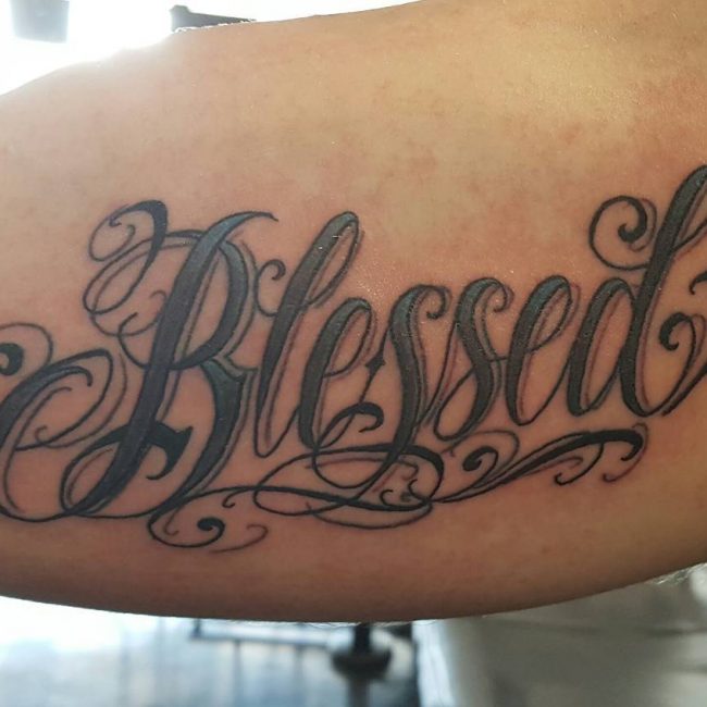 Black shaded simple blessed tattoo on body