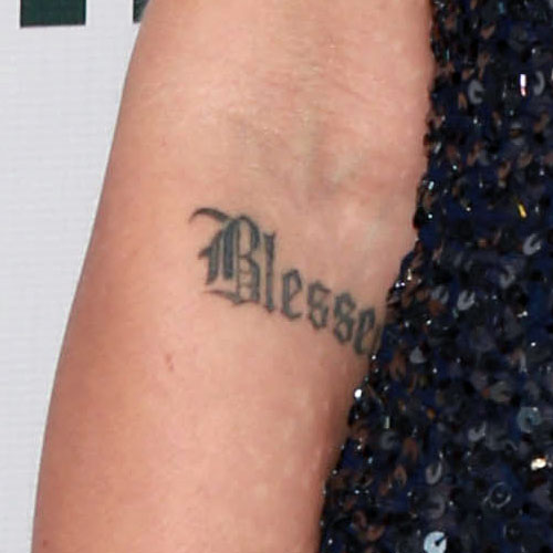 Black simple blessed tattoo below elbow