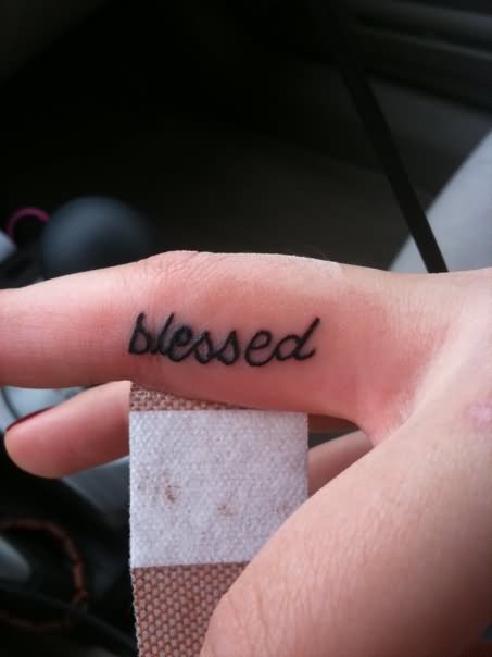 Black simple blessed tattoo on finger