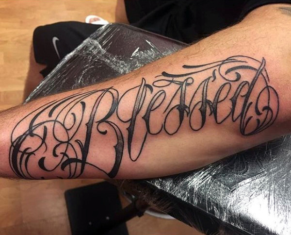 Black simple blessed tattoo on full forearm for men