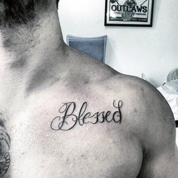Black simple blessed tattoo on upper left front shoulder for men