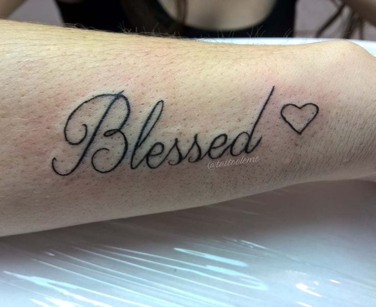 Black simple blessed with heart tattoo on forearm