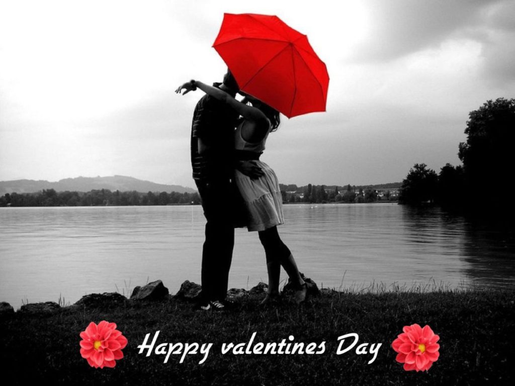 happy valentine’s day love couple kissing behind umbrella