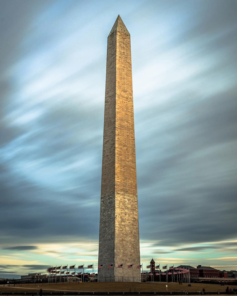 beautiful view of the washington monument with black clouds