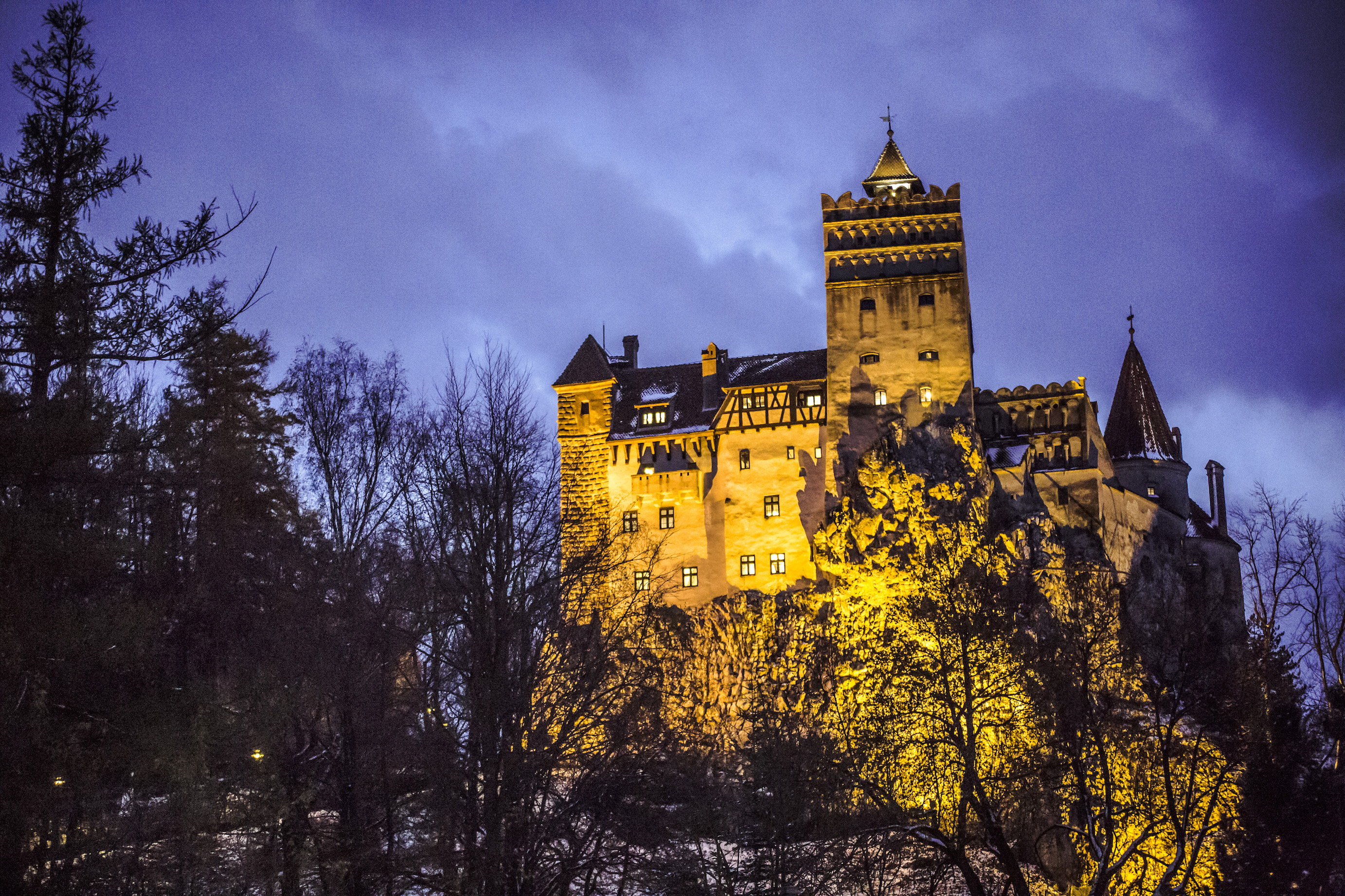 bran castle lit up at night
