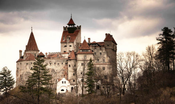bran castle with black clouds at sunset
