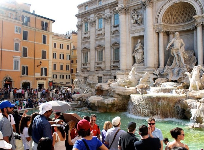 tourists enjoying the Trevi Fountain view