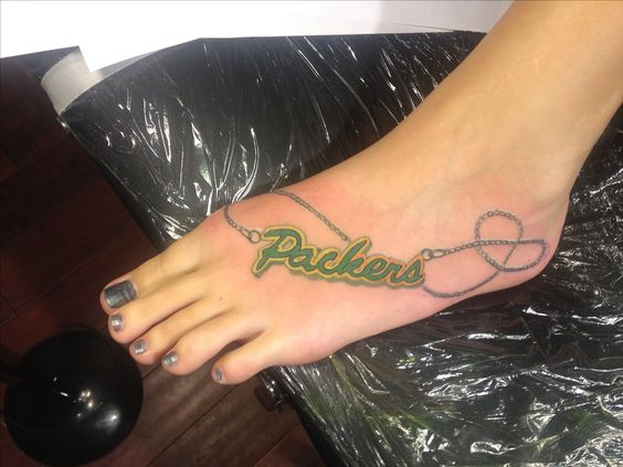 Girly green bay packers tattoo on foot