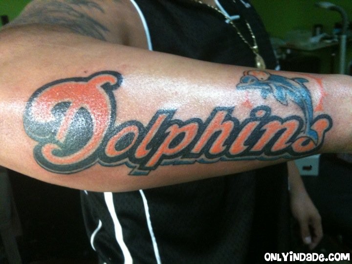 Miami Dolphins tattoo on men's outer forearm