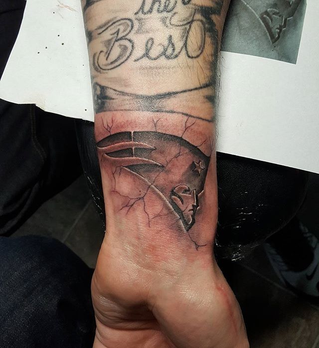 Wonderful Engraved Cracked Skin New England Patriots tattoo On Wrist