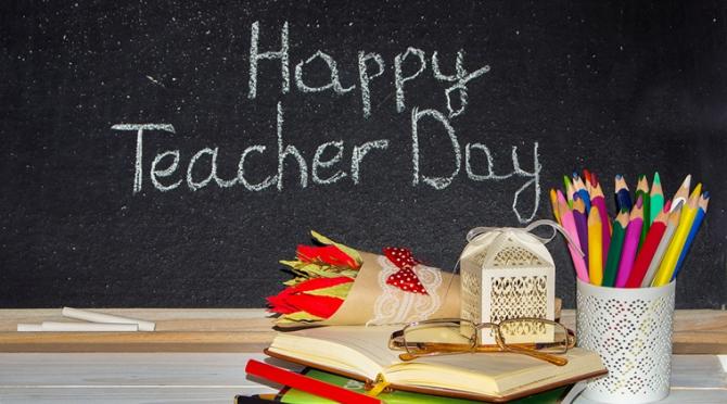 happy teachers day black board with pencils
