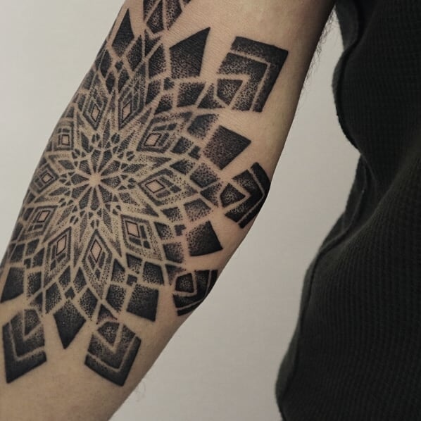Black geometric tattoo on arm by Black Ink Power