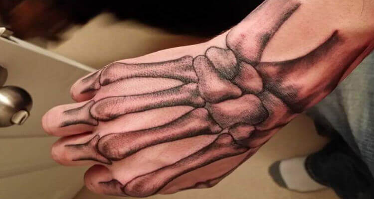 Grey Ink Skeleton Hand Tattoo Design