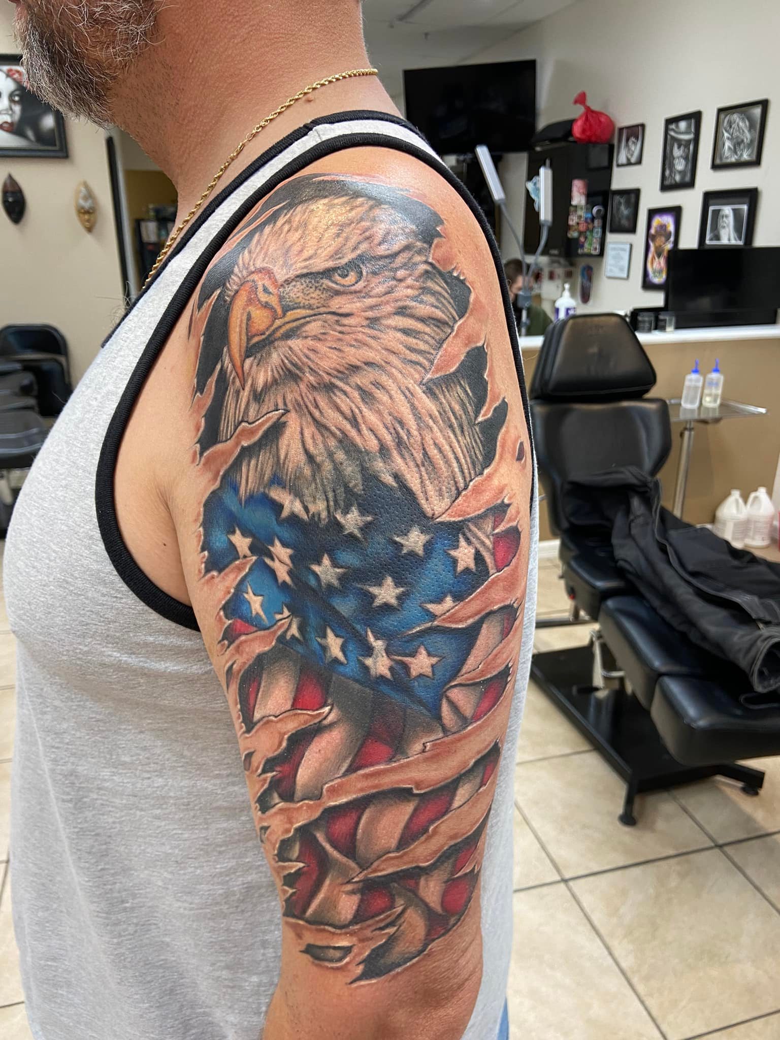 Ripped Skin Bald Eagle and American Flag Tattoo On Half Sleeve.