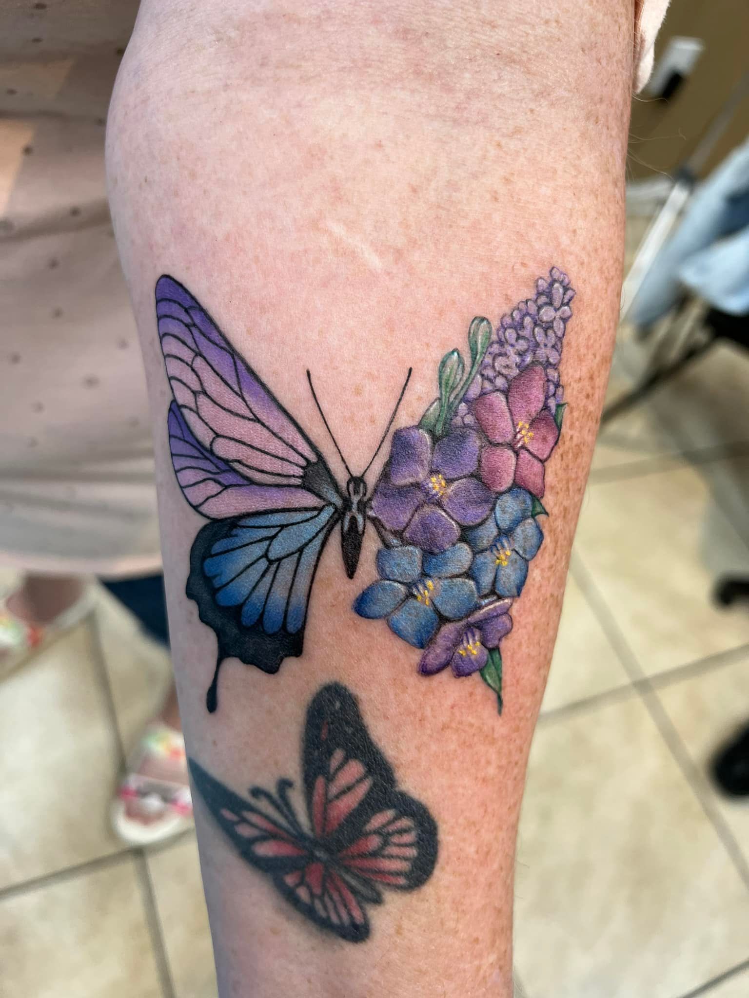 Colorful butterfly tattoo on forearm